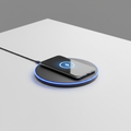Sleek matte black wireless charging pad with blue LED glow ring